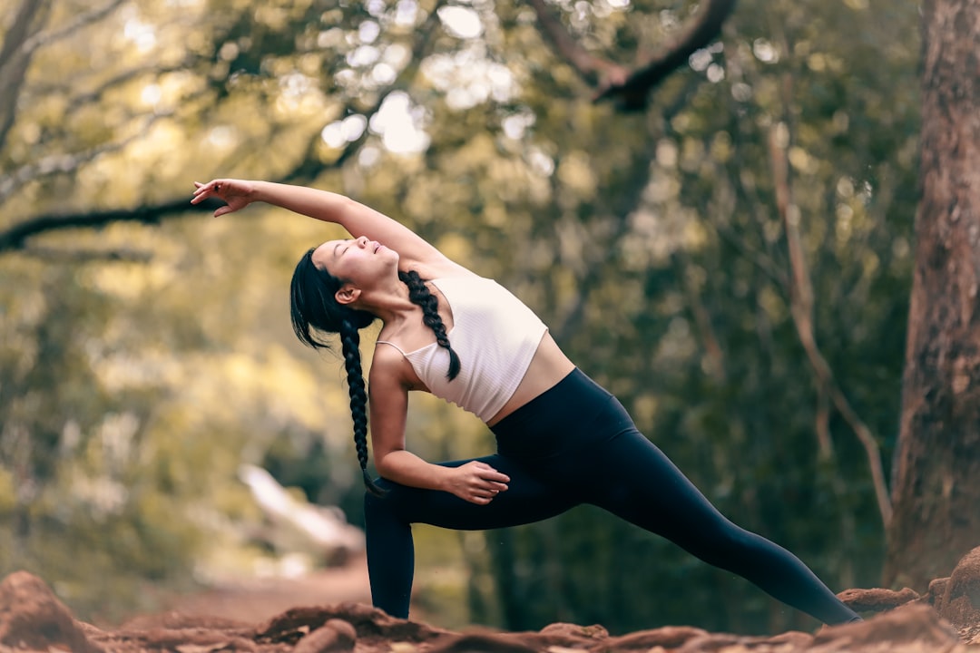 woman-in-white-tank-top-and-black-leggings-doing-yoga-during-daytime-mihbipd5-qw